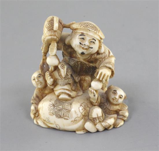 An ivory netsuke of Daikoku and two boys, Meiji period, height 4cm